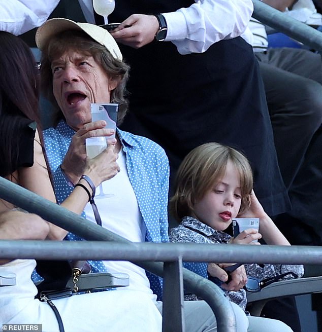 The Rolling Stones rocker cut a casual figure in an open blue shirt which he layered over a white top and teamed with jeans and a baseball cap