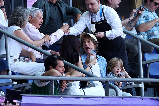 The family sat in swanky seats with great view of the games in the Stade de France as they were served with champagne by a waiter