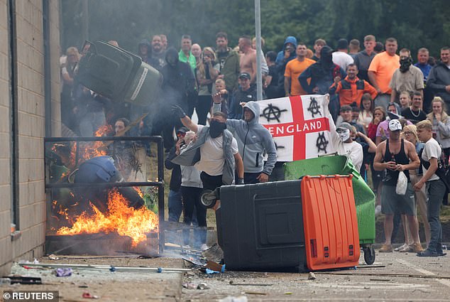 Thugs during a far-right anti-immigration protest in Rotherham on August 4 - thought to have been sparked by online hate mobs