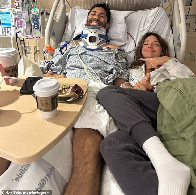 In one photo, his wife Laura Perlongo could be seen cuddling up next to him in his bed, the two of them pulling brave smiles for the camera