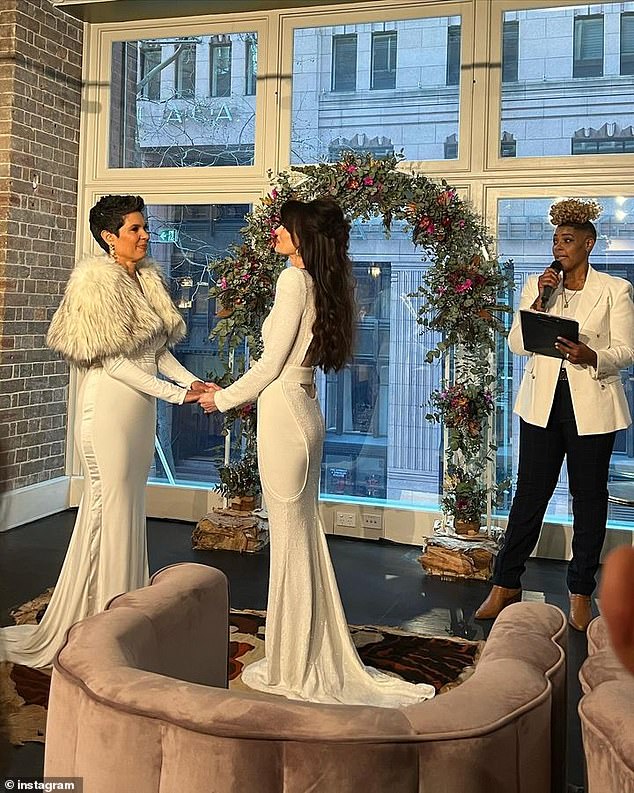 The two said 'I do' in front of a floral arch placed before a huge window at what appeared to be an upper floor location