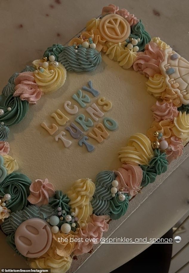 The doting mum also made sure to show off the beautiful birthday cake which featured smiley faces, multi-coloured icing and edible pearls and beads