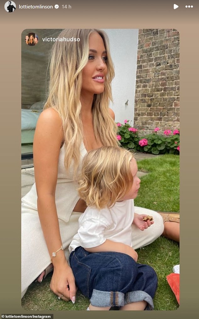 Lottie wore a cream waistcoat, fastened with a flower and a pair of matching floor-length cream trousers as she posed for pictures with her adorable little boy