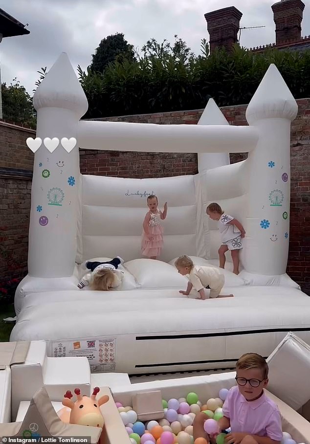 Lottie showed her fans a large white bouncy castle and miniature ball pit with small children bouncing around and enjoying themselves