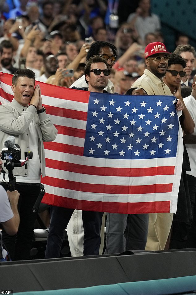 He put on an animated display and waved an American flag as the team held off France 98-87 in the gold medal match