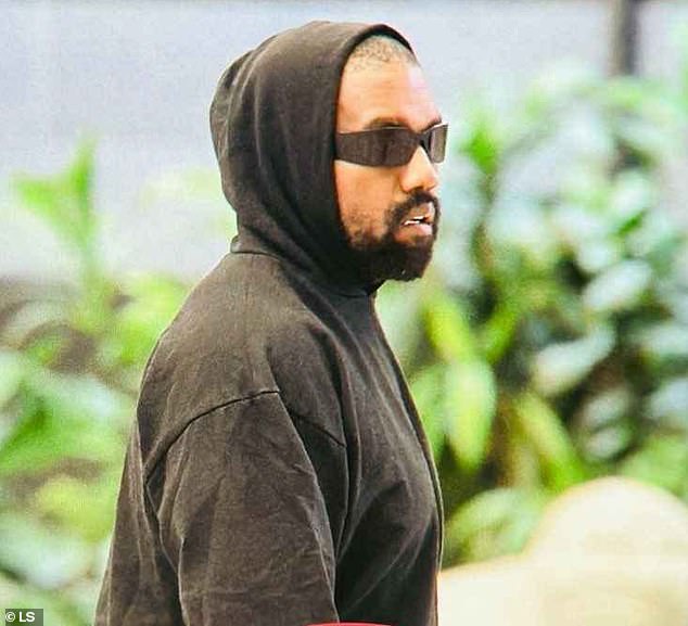 Kanye West attempted to remain incognito in a black hoodie and shorts as he left Seoul, South Korea