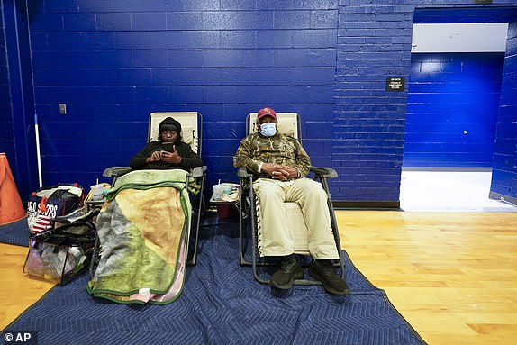 Mary Tanner Jerome Tanner, of Tallahassee, sit inside an evacuation shelter ahead of Hurricane Helene, expected to make landfall here today, in Leon County, Fla., Thursday, Sept. 26, 2024. (AP Photo/Gerald Herbert)