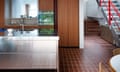 Stainless-steel units in the kitchen with a view of the galvanised steel staircase.