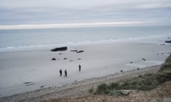 French police officers patrol the beach in search of migrants in Wimereux, northern France.