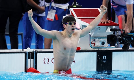 Zhanle Pan of China celebrates after winning gold in a world record time in the men's 100m freestyle final.