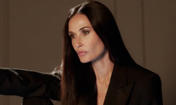 Portrait of Demi Moore with long dark hair and wearing a tuxedo jacket