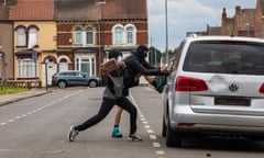 Rioters vandalise a car as a protest in Middlesbrough turned violent.