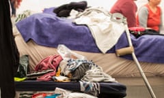 Untidy room with overflowing suitcase