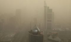 A view of skyscrapers barely visible through a dense brown fog