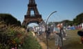 Spectators cool off under water misters in front of the Eiffel Tower