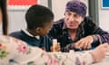 Stevie Van Zandt sat at a table talking to a child