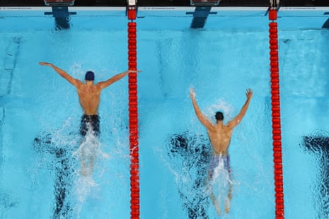 Leon Marchand of France (left) and Kristof Milak of Hungary power through the water.