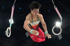 Shinnosuke Oka, of Japan, dismounts the rings during the men’s artistic gymnastics all-around finals, where he won gold