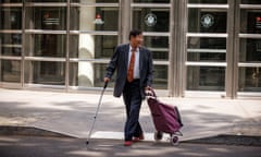 a man in a suit and tie crosses a street