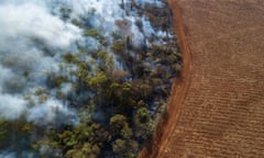 Aerial view of triggered forest fire and deforestation for plating soybeans in Amazon rainforest