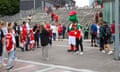 Arsenal fans queuing to have a photograph taken with  mascot Gunnersaurus this week