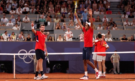 Austin Krajicek and Rajeev Ram of the United States celebrate after winning match point against Rafael Nadal and Carlos Alcaraz of Spain during their men's doubles quarter-final match.