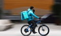 A Deliveroo rider cycles through central London.