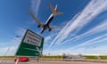 BA plane flies low with Heathrow signage in foreground