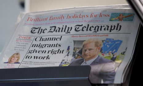 Copies of the Daily Telegraph are displayed on a rack in a supermarket in London