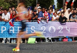 Spectators cheer on competitors during the men’s individual triathlon