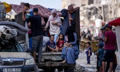 Adults and children on the back on a lorry, the women in headscarves