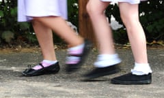 Feet of two schoolgirls walking along