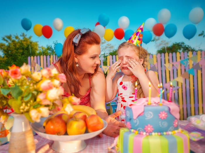 A colorful child's birthday party with a mom cheering up a crying daughter