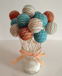 Aqua, blue and white cake pops arranged in a mason jar.