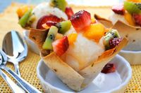 Coconut ice cream in edible bowls with tropical salsa.