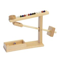 a wooden toy with marbles and an abacust on it's side