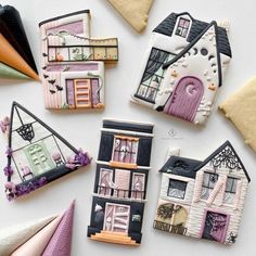 decorated cookies are arranged in the shape of houses