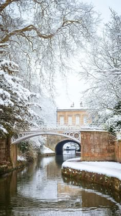 a bridge over a river with snow on the ground