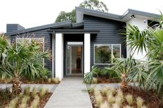 a house that has some plants in front of it