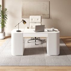 a white desk with a laptop on it in front of a chair and potted plant