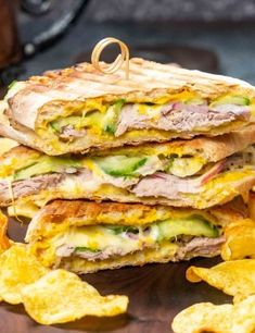 three quesadillas stacked on top of each other with chips in front of them