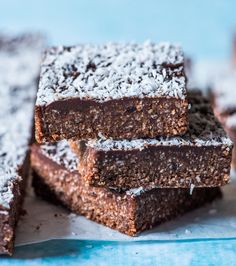 some brownies are stacked on top of each other with powdered sugar all over them