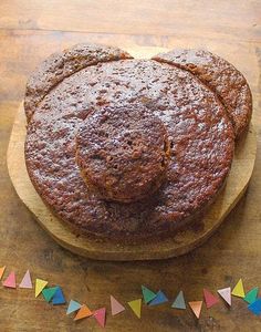 two cakes sitting on top of a wooden cutting board