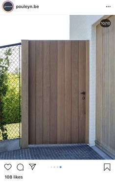 two wooden doors in front of a white house