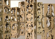 several cardboard boxes with faces cut out of them