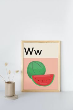 a watermelon print on a wall next to a vase with flowers in it