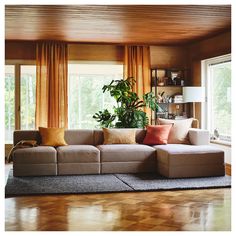 a living room filled with furniture and lots of windows