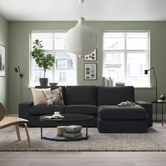 a living room with blue walls and furniture in the center, along with a white rug on the floor