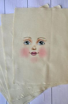 four pieces of cloth with an image of a child's face on it