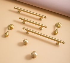 brass handles and knobs on a beige surface